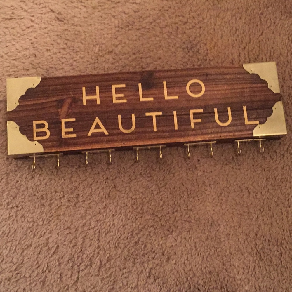 Necklace holder. Dark wood/gold lettering